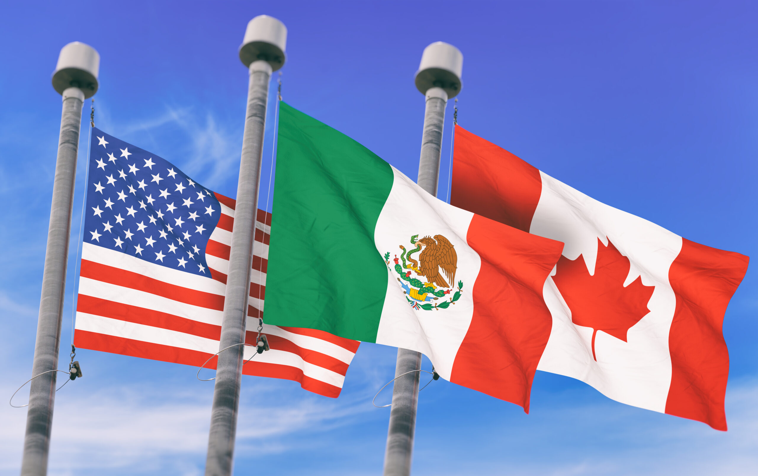 Canada,,Mexico,And,Us,Flags,Over,Blue,Sky,,Conceptual,Image